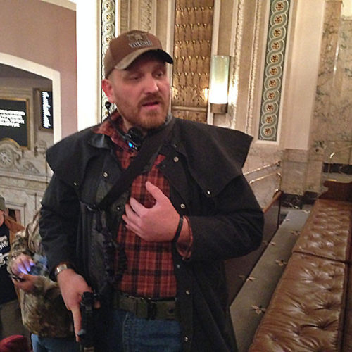 Jason McMillan carrying a military-style pistol in the Washington state House gallery in 2015. Beginning in January of 2018, all guns were banned from the state Senate gallery. | CREDIT: Austin Jenkins/N3