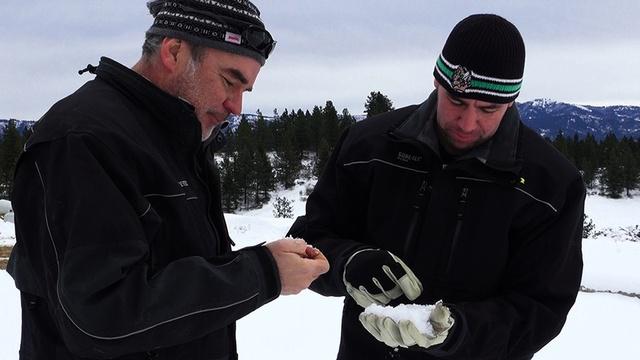 Idaho Power's Derek Blestrud and Brandal Glenn study the type of snow that's falling as a result of cloud seeding. CREDIT: AARON KUNZ