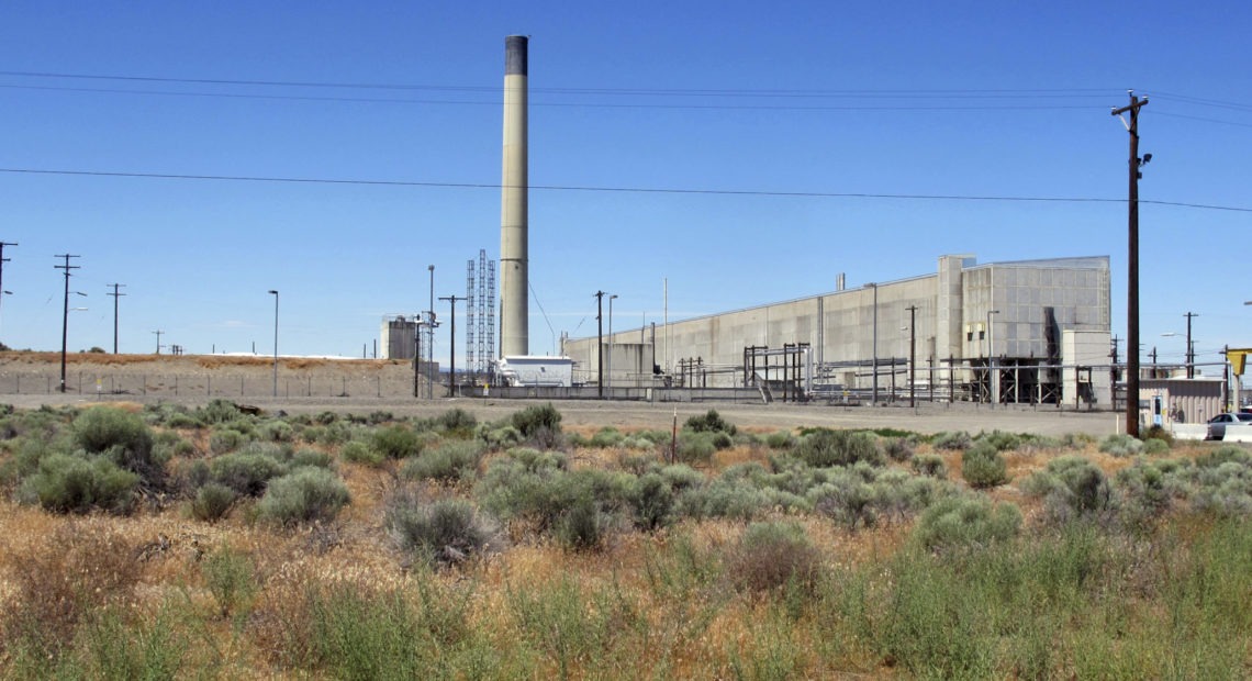 In this file photo taken June 13, 2017, the Plutonium Uranium Extraction Plant, right, stands adjacent to a dirt-covered rail tunnel, left, containing radioactive waste, amidst desert plants on the Hanford Nuclear Reservation near Richland, Wash. The U.S. Department of Energy said Tuesday, Nov. 14, 2017, that workers have finished stabilizing the partially-collapsed tunnel containing radioactive wastes left over from the production of plutonium for nuclear weapons. CREDIT: AP PHOTO/NICHOLAS K. GERANIOS