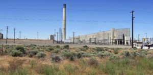 In this file photo taken June 13, 2017, the Plutonium Uranium Extraction Plant, right, stands adjacent to a dirt-covered rail tunnel, left, containing radioactive waste, amidst desert plants on the Hanford Nuclear Reservation near Richland, Wash. The U.S. Department of Energy said Tuesday, Nov. 14, 2017, that workers have finished stabilizing the partially-collapsed tunnel containing radioactive wastes left over from the production of plutonium for nuclear weapons. CREDIT: AP PHOTO/NICHOLAS K. GERANIOS
