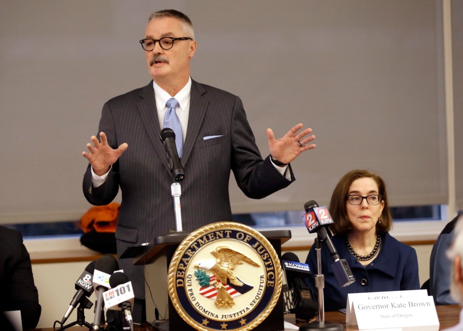 U.S. Attorney for the District of Oregon Billy J. Williams, left, speaks at a marijuana summit in Portland, Oregon, Friday, Feb. 2, 2018, as Oregon Gov. Kate Brown sits at right. CREDIT: DON RYAN
