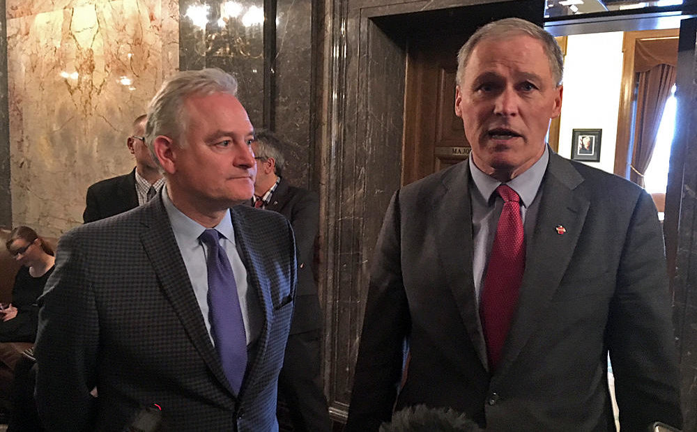 Washington Gov. Inslee speaks with reporters alongside Democratic state Sen. Reuven Carlyle after the Senate voted to abolish the death penalty.