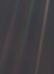 This color image, known as the "Pale Blue Dot," is part of the first-ever portrait of the solar system, which was taken by Voyager 1 in 1990. See that tiny dot caught in the middle of the rightmost beam? That's us: all of us. CREDIT: NASA