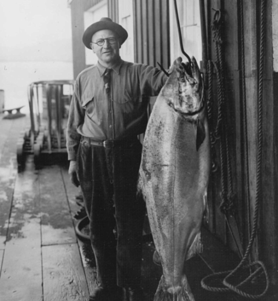 Fisherman Tony Canessa with an 85-pound chinook he caught near Astoria, Oregon, in 1925. CREDIT: U.S. FISH AND WILDLIFE SERVICE