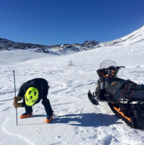 A snow-machine rider takes a snowpack reading as part of Community Snow Observations, a NASA-sponsored citizen science project. CREDIT: OREGON STATE UNIVERSITY