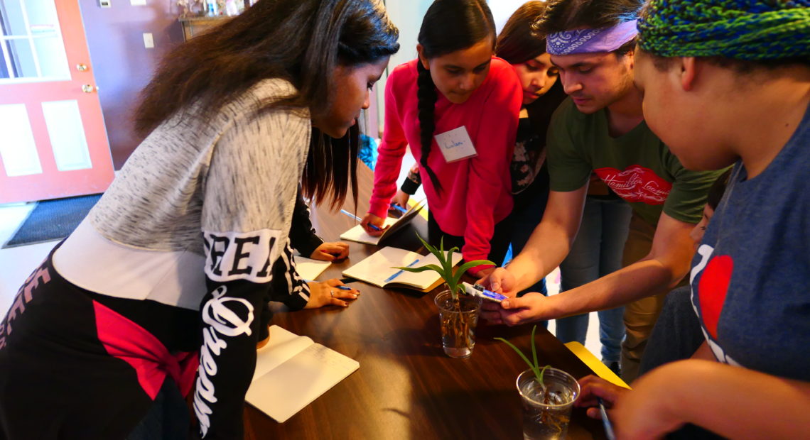 UW student Joshawah Eagle-Bear (center right) leads 6th grade students on a workshop titled "Water Is Life" at Campbell Farm in Wapato, Wash. CREDIT: ZIHAN CAO