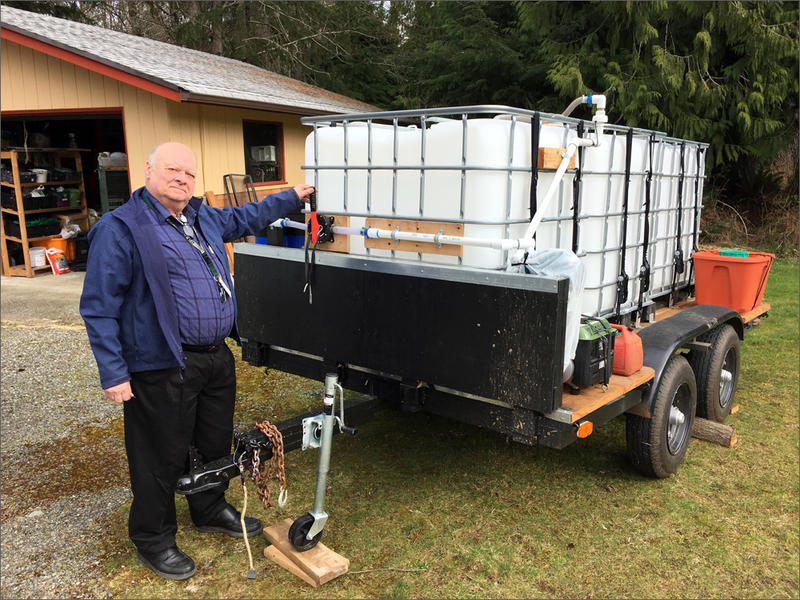 Jim Buck of Joyce, Washington, shows off the community's portable water filtration unit for use in case of a major earthquake. CREDIT: TOM BANSE/N3