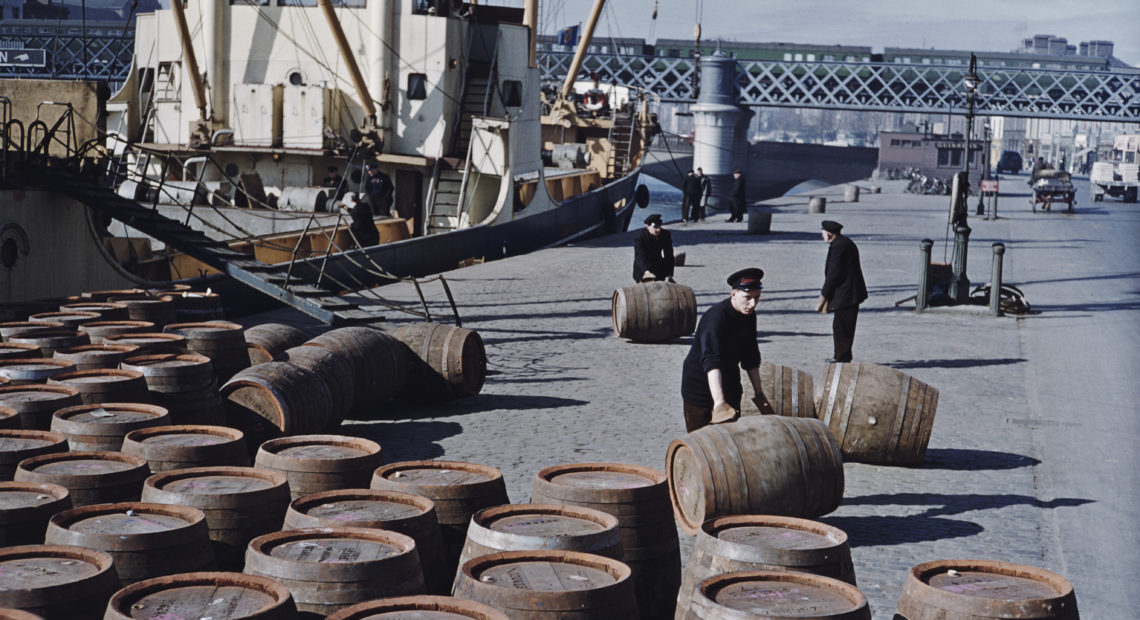 Workers roll potentially lifesaving barrels of Guinness in June 1955 on a quayside in Dublin.