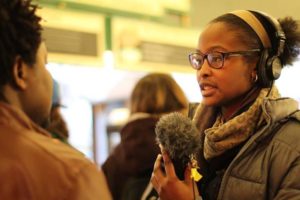 A RadioActive participant conducts an interview at Pike Place Market in Seattle.