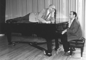 Kasell decides to take a publicity photo shoot up a notch while Wait Wait... Don't Tell Me! host Peter Sagal tickles the ivories. CREDIT: WAIT WAIT...DON'T TELL ME/NPR