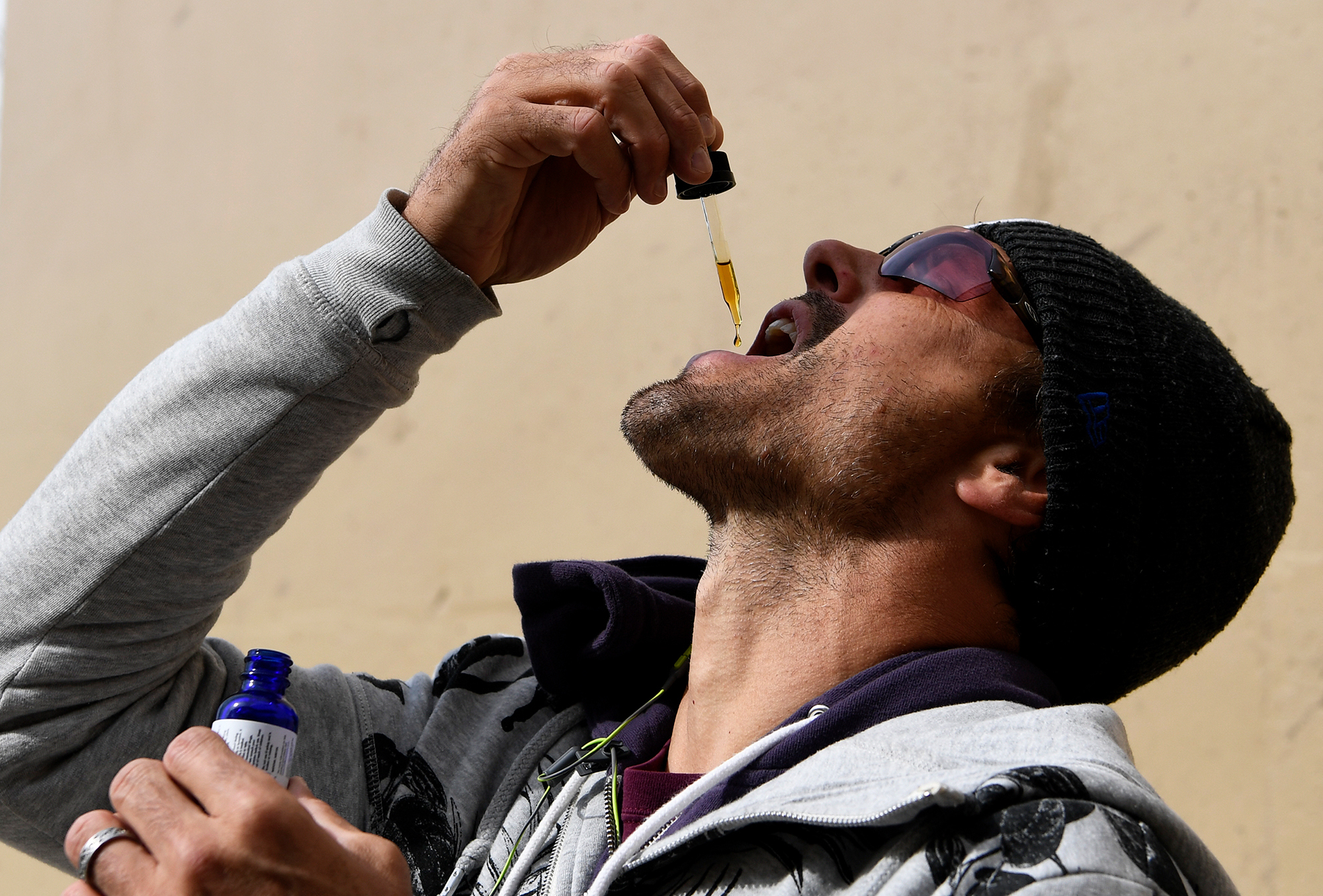 Former Denver Broncos quarterback Jake Plaummer takes a dose of cannabidiol in Colorado in 2016. CBD oil, often dispensed under the tongue with a dropper, has been regulated as a supplement in the U.S., not a medicine. So strength and purity may vary from brand to brand, or even bottle to bottle, scientists say. CREDIT: AARON ONTIVEROZ