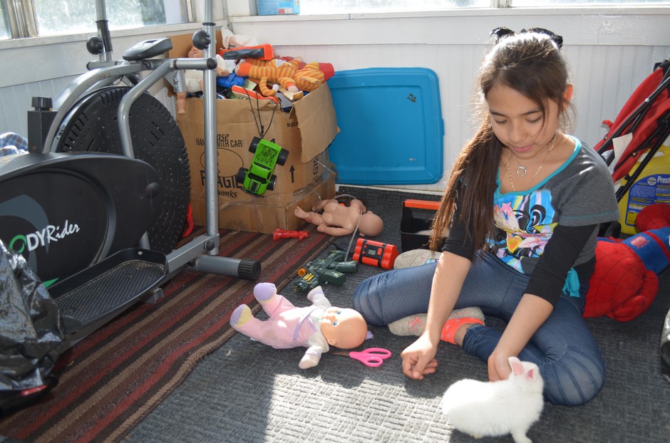 Ten-year-old Azul plays with her pet rabbit at her family's home in Wapato, Washington. CREDIT: COURTNEY FLATT