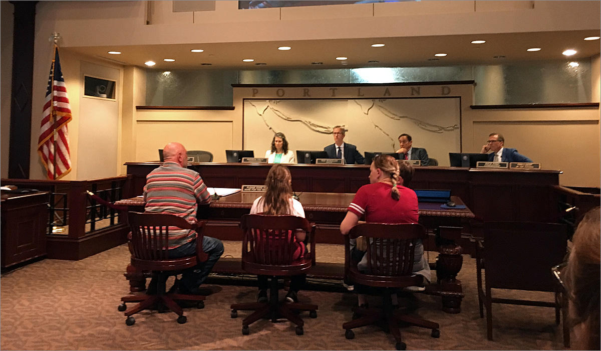 Jim Atwood, left, and his family testified Wednesday against a mandatory earthquake retrofit resolution at the Portland City Council. CREDIT: TOM BANSE