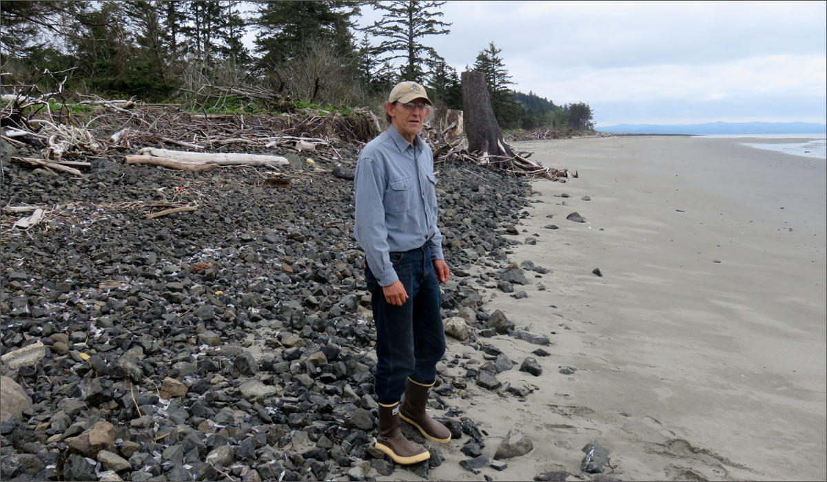 David Cottrell stands on an example of ''dynamic revetment'' protecting shoreline from further erosion at Washaway Beach. CREDIT: TOM BANSE