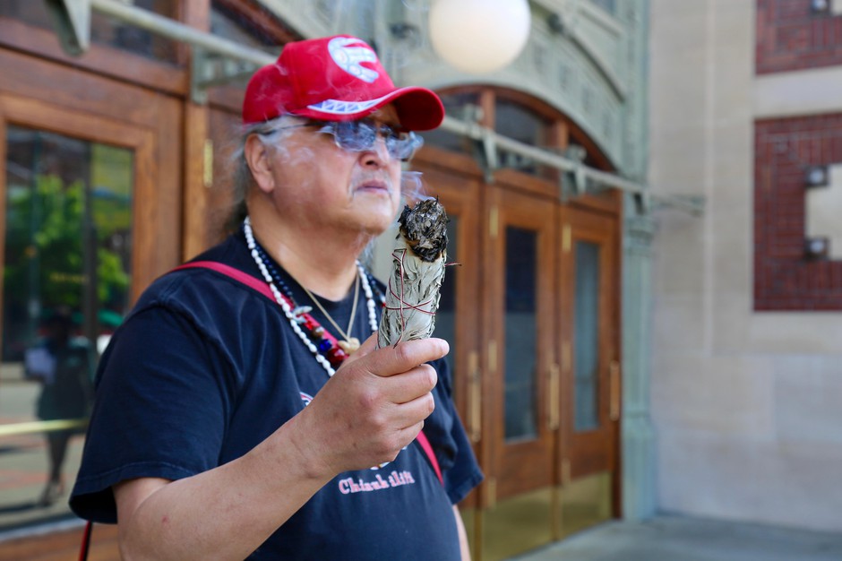 A member of the Chinook Indian Nation burns sage outside the federal courthouse. The southwest Washington coastal tribe have been fighting for federal status for more than a century. CREDIT: MOLLY SOLOMON