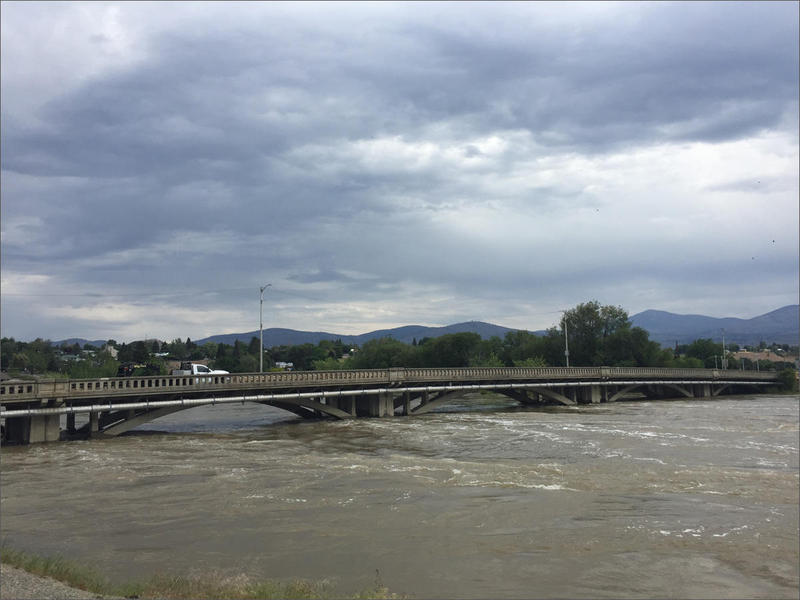 The flooded Okanogan River flowing through downtown Omak, Friday, May 18, 2018.