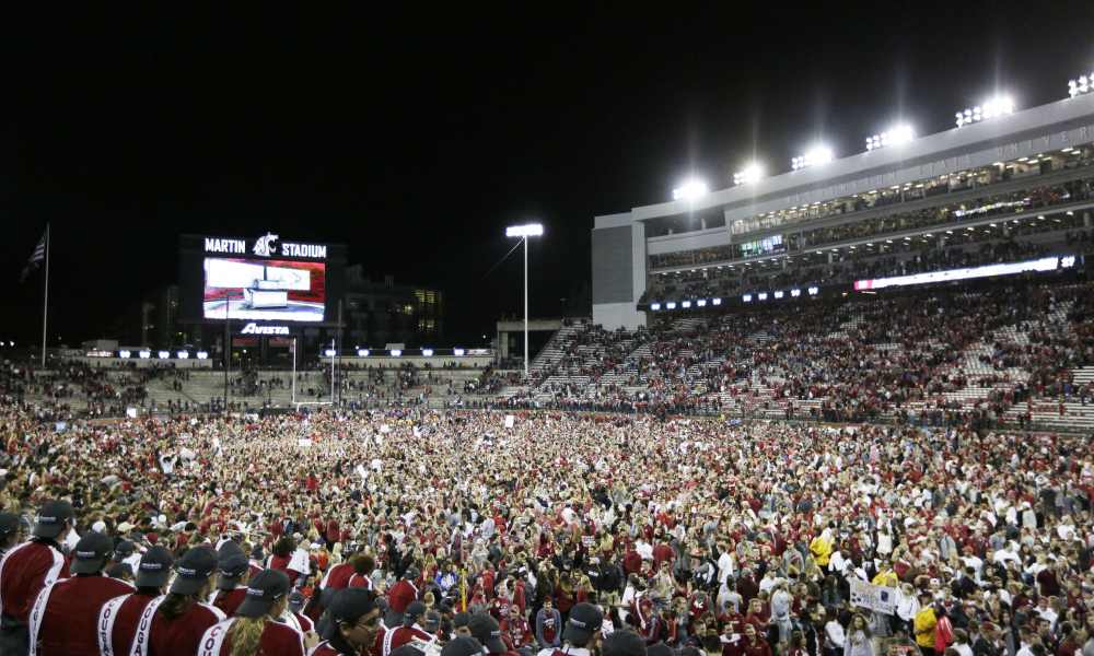 Fans and players celebrate Washington State's 30-27 win over Southern California in an NCAA college football game in Pullman, Wash., Friday, Sept. 29, 2017. (AP Photo/Young Kwak) ORG XMIT: WAYK111