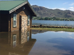 A home along Lake Osoyoos in Oroville, Washington, is already inundated with flood water. A near record snow year in southern British Columbia combined with temperatures in the upper 80s means flood waters will continue to rise. CREDIT: EMILY SCHWING/NORTHWEST NEWS NETWORK