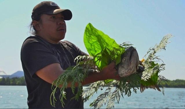 A member of Puget Sound's Swinomish tribe participating in a ceremonial salmon blessing. Northwest tribes hold vigils along the Columbia River to pray for the return of salmon. CREDIT: KUOW PHOTO/KATIE CAMPBELL