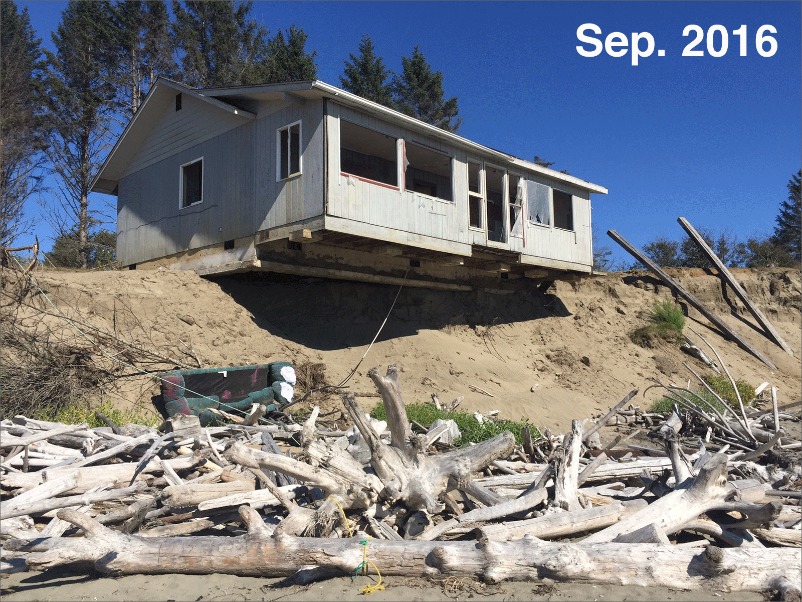 In 2016, we photographed this abandoned home perched precariously on the bank and predicted it would probably be the next to fall. In May 2018, it's mostly still there. CREDIT: TOM BANSE AND KEVIN MOONEY