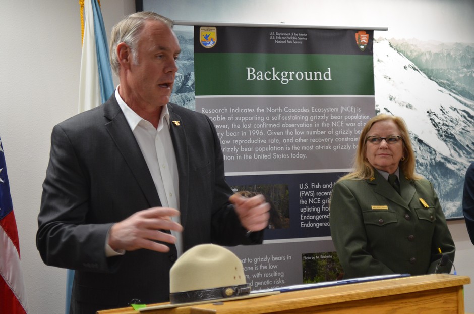 Interior Secretary Ryan Zinke speaking on March 23, 2018, about the restarted re-introduction process for grizzly bears in Washington’s North Cascades. Looking on is Karen Taylor Goodrich, the superintendent of the North Cascades National Park Service Complex. CREDIT: EILIS O'NEILL