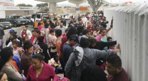 In this June 4, 2018 photo, people seeking political asylum in the United States line up to be interviewed in Tijuana, Mexico, just across the U.S. border south of San Diego.