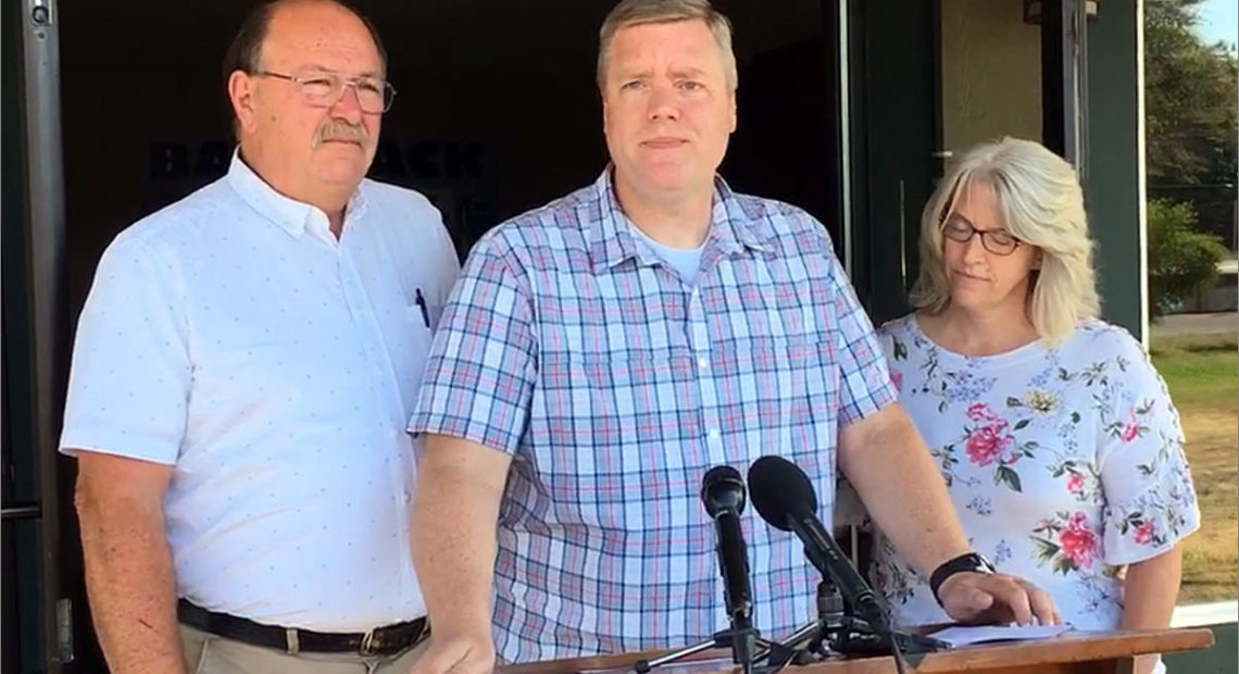 Pastor David George, flanked by his wife and the Oakville, Washington, fire chief, describes pulling his pistol and fatally shooting a gunman at the Tumwater Walmart on Father's Day. CREDIT: AUSTIN JENKINS/N3