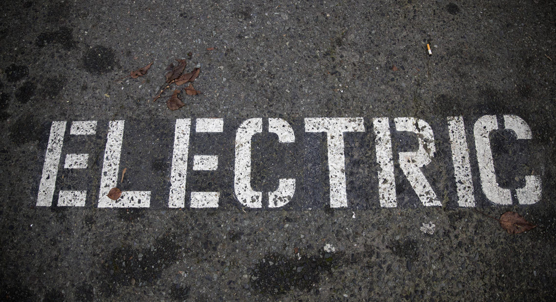 A parking spot is designated for electric vehicles at the charging station outside of the Ballard Market on Monday, December 11, 2017, in Seattle. CREDIT MEGAN FARMER - KUOW