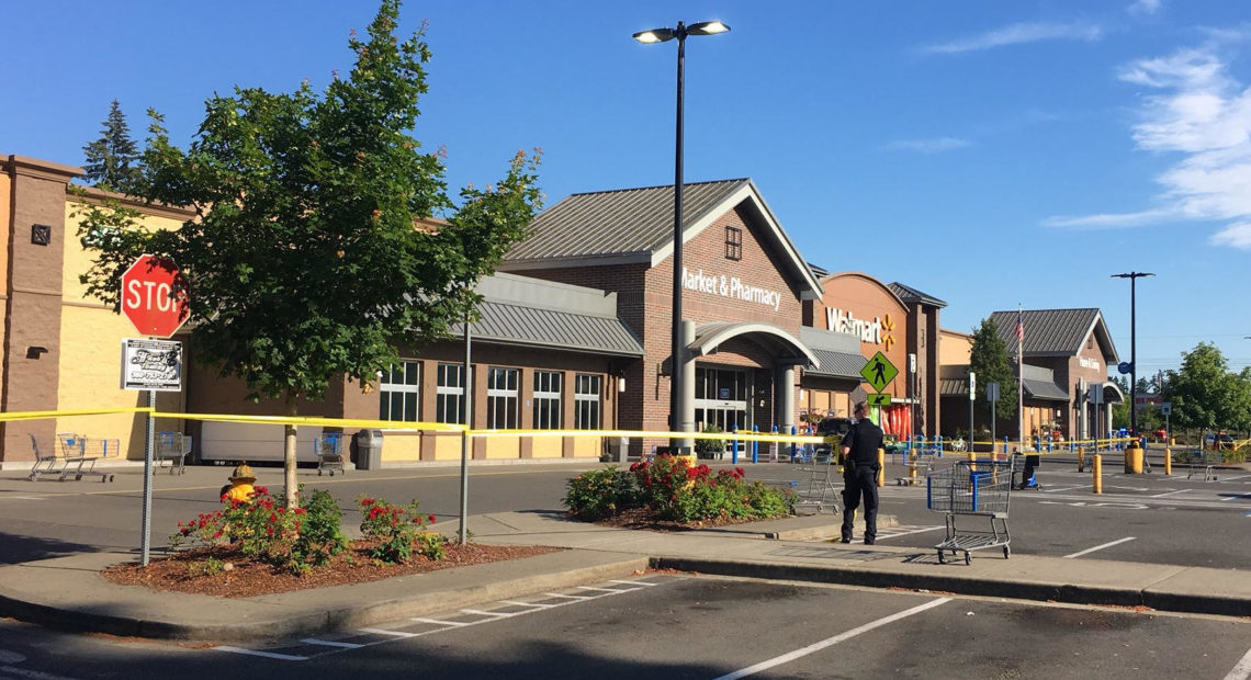 Police block the scene outside a Walmart in Tumwater, Wash.,, where a gunman shot a driver, then was himself shot to death June 17, 2018. CREDIT: AUSTIN JENKINS/N3