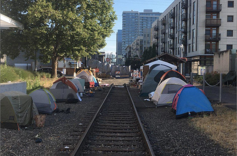 Tents line trolley tracks outside the ICE facility in Southwest Portland, Wednesday, June 20, 2018. CREDIT: DIRK VANDERHART