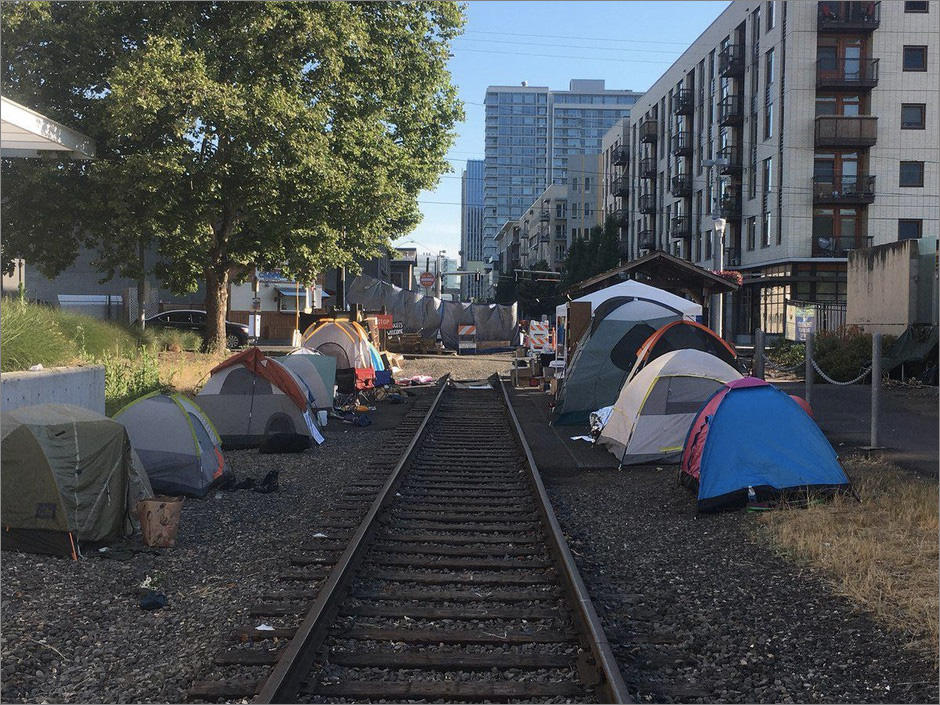 Tents line trolley tracks outside the ICE facility in Southwest Portland, Wednesday, June 20, 2018. CREDIT: DIRK VANDERHART