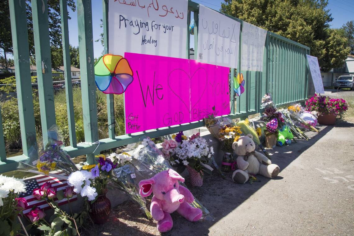 Piles of flowers and stuffed animals kept growing Tuesday at outside the Wylie Street Station Apartments in Boise, site of the mass stabbing Saturday that killed a girl who was having her third birthday party and injured five other children and three adults. CREDIT: DARIN OSWALD