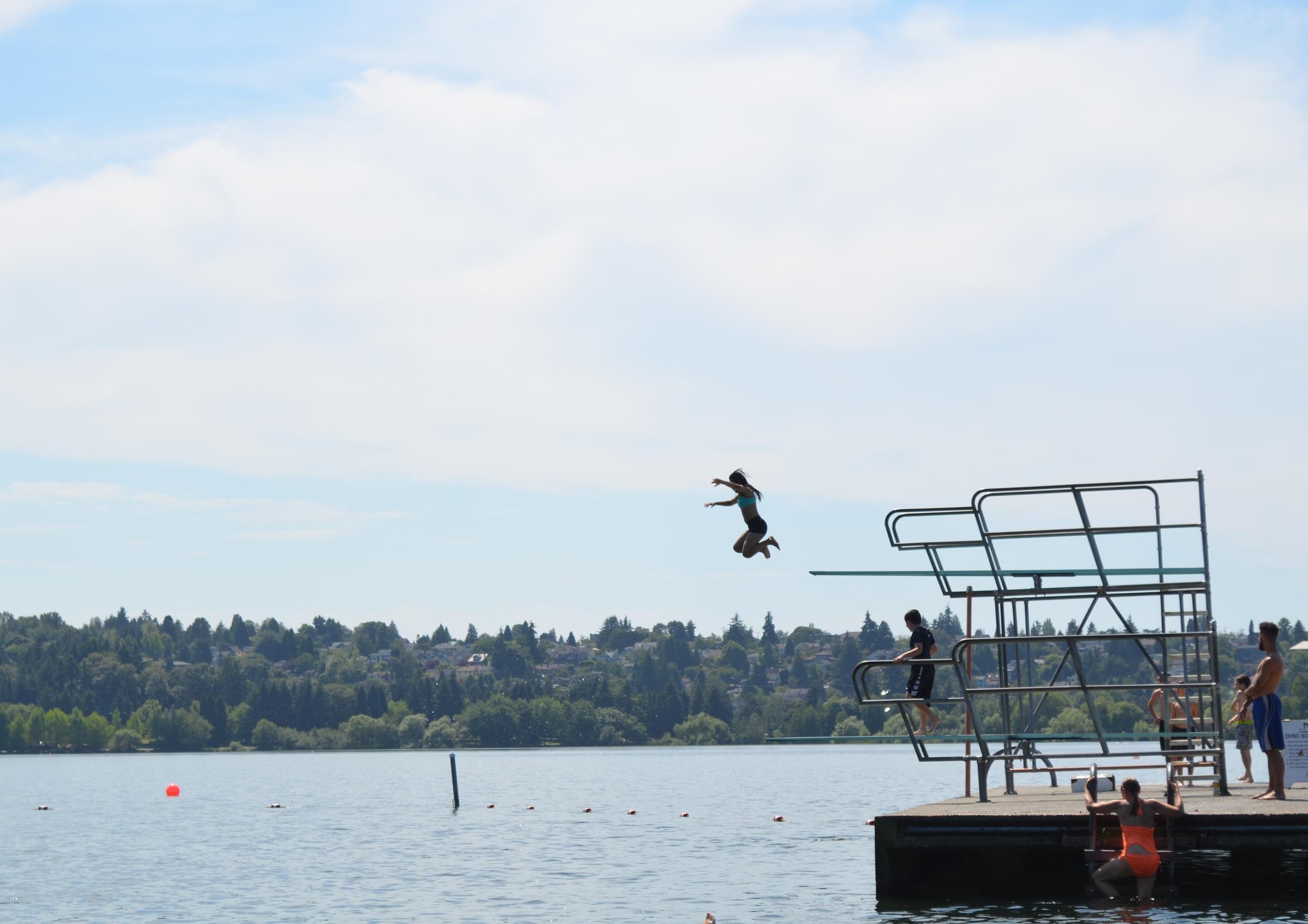 A girl jumps off the Green Lake diving board on a hot summer day. CREDIT: EILIS O'NEILL
