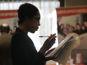 Joana Dudley looks at a list of job prospects at a job fair in Miami Lakes, Fla., in January. In the government's June jobs report, the unemployment rate ticked up to 4 percent with more people entering the labor force. CREDIT: Lynne Sladky/AP