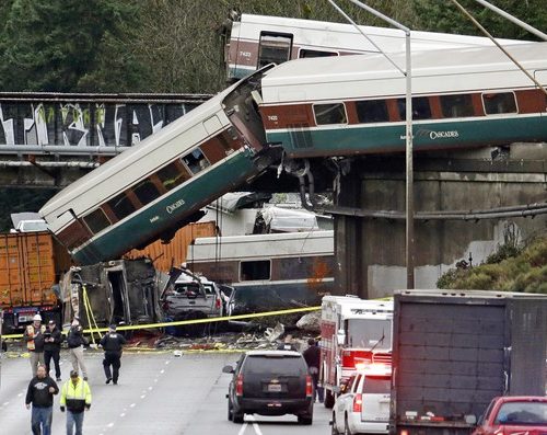 Cars from an Amtrak train lie spilled onto Interstate 5 below alongside smashed vehicles as some train cars remain on the tracks in DuPont, Washington. CREDIT: ELAINE THOMPSON/AP