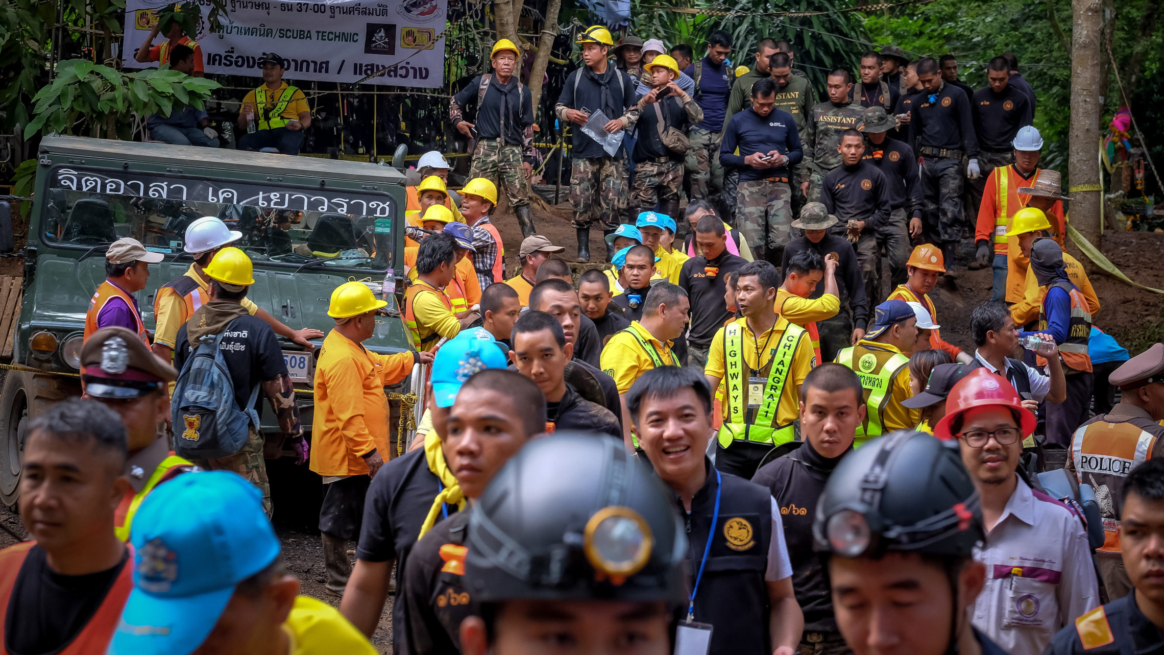 Hundreds of rescuers gather outside the cave Tuesday in Chiang Rai to help load equipment and aid efforts to rescue the 12 boys aged 11 to 16 and their 25-year-old coach. CREDIT: LINH PHAM