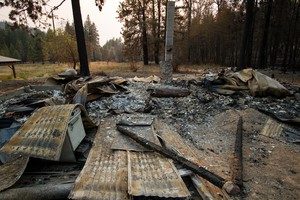 A burned cabin that was destroyed in Washington’s 2014 Carlton Complex wildfire. Creative Commons licensed by Adam Cohn