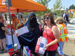 PBEM's Laura Hall, right, explained the twin bucket system to Layla Assem of East Portland. CREDIT: TOM BANSE