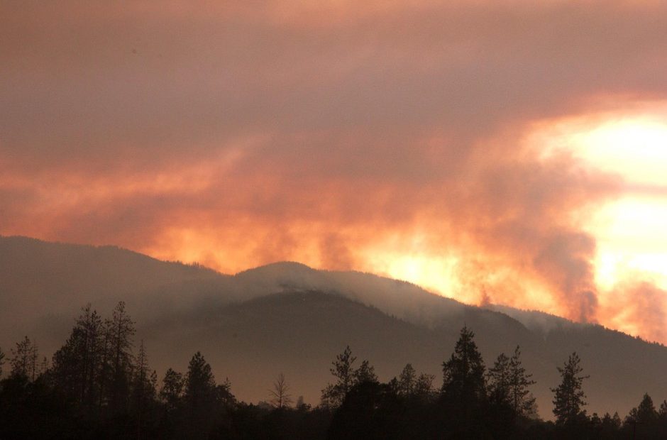 The smoke of the Taylor Creek Fire still plumes behind the Joint Information Center, just outside of Grants Pass, OR. CREDIT: USFS/DARREN STEBBINS
