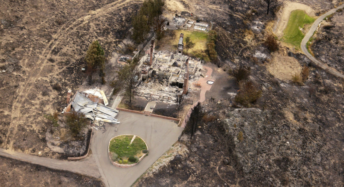 In this July 24, 2014, the remains of structures that were destroyed by wildfires near Pateros, Wash. The Carlton Complex fire was the largest in Washington State history. CREDIT: AP IMAGES/TED S. WARREN