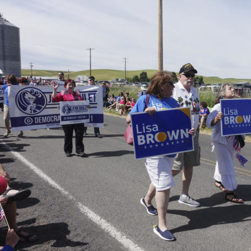 Supporters of Lisa Brown, the presumed Democratic opponent to Republican U.S. Rep. Cathy McMorris Rodgers, walk in the Johnson 4th of July Parade in Johnson, Wash. CREDIT: AP PHOTO/TED S. WARREN