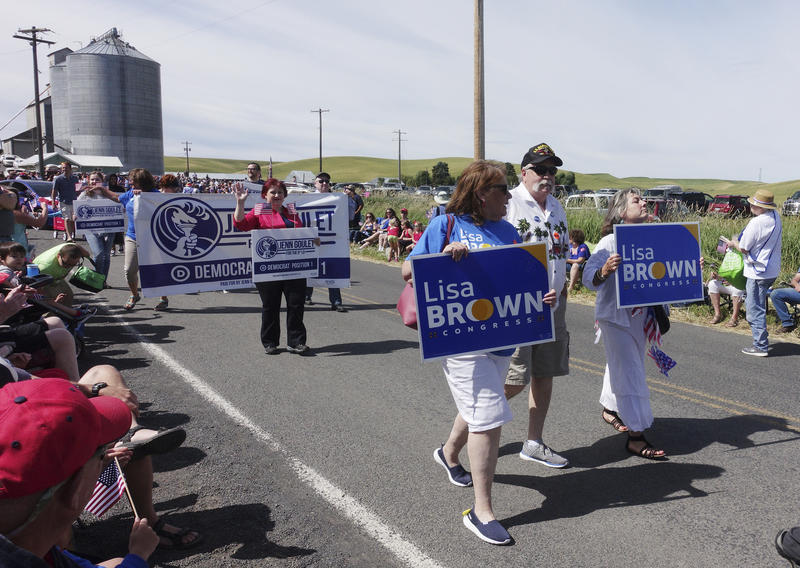 Supporters of Lisa Brown, the presumed Democratic opponent to Republican U.S. Rep. Cathy McMorris Rodgers, walk in the Johnson 4th of July Parade in Johnson, Wash. CREDIT: AP PHOTO/TED S. WARREN