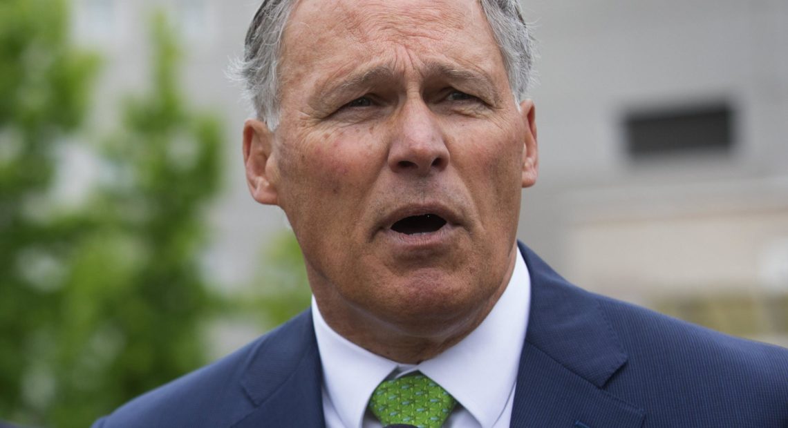Gov. Jay Inslee, shown here at the Federal Detention Center in SeaTac in June, has traveled on behalf of the Democratic Governors Association more than a dozen times in 2018. CREDIT: ELLEN M. BANNER