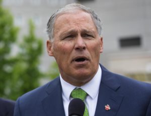 Gov. Jay Inslee, shown here at the Federal Detention Center in SeaTac in June, has traveled on behalf of the Democratic Governors Association more than a dozen times in 2018. CREDIT: ELLEN M. BANNER