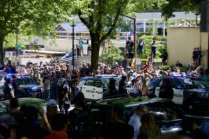 Patriot Prayer, Proud Boys and counter-protesters shout at one another from across a street in Downtown Portland Saturday, Aug. 4. CREDIT: ERICKA CRUZ GUEVARRA/OPB