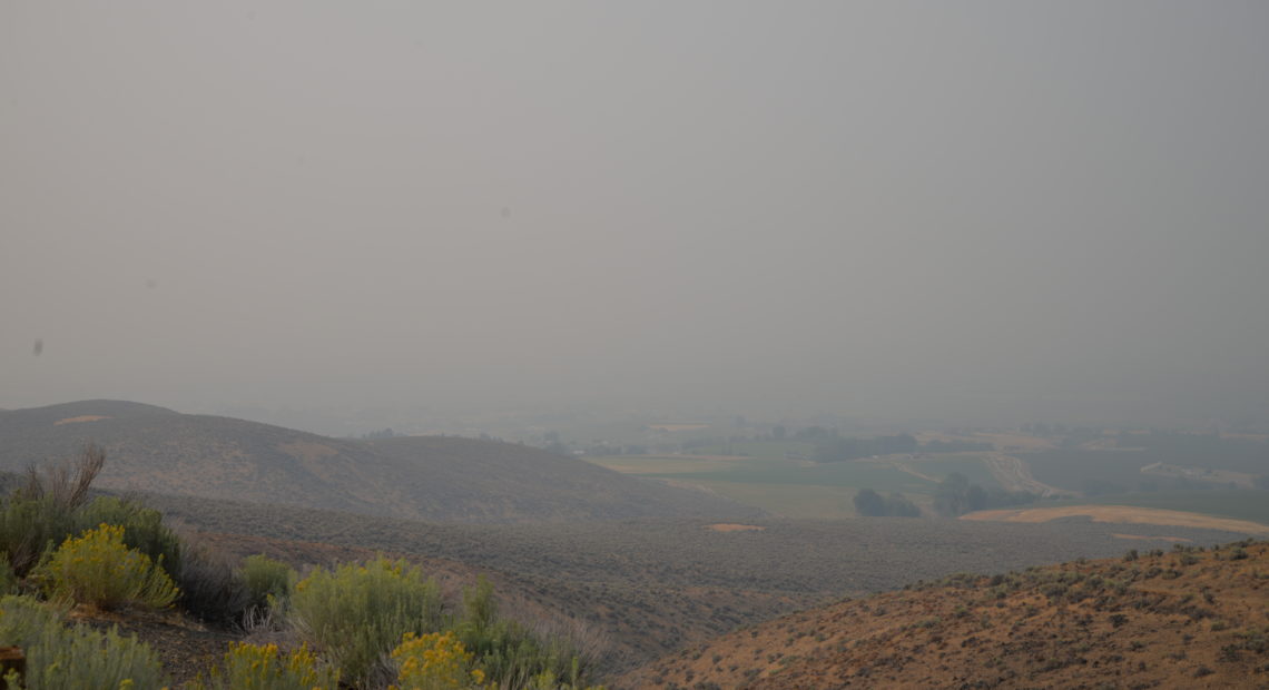 Smoky skies in Central Washington this week have made it hard to see distant mountains, and harder for some farmworkers to breathe clean air. CREDIT: ESMY JIMENEZ/NWPB