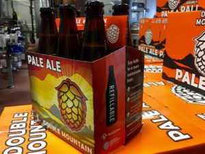 Double Mountain's new six-pack has a label letting customers know the bottles inside are refillable. The bottles themselves also have the word 