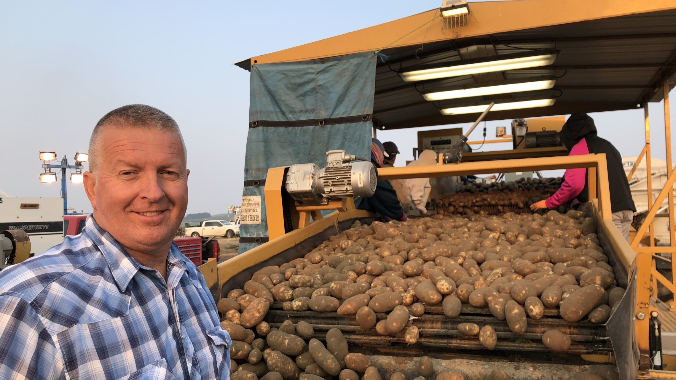 Mike Pink owns about 1,600 acres of potatoes. He says he can’t afford a week of smoky conditions that might stall his crop. CREDIT: ANNA KING/N3
