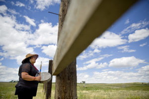 Roxanne White, whose aunt was murdered in 1996, sings and drums a women's warrior and honor song created for missing and murdered indigenous women, before joining a search in Valier, Mont., for Ashley HeavyRunner Loring, who disappeared last year from the Blackfeet Indian Reservation, Wednesday, July 11, 2018. CREDIT: DAVID GOLDMAN/AP