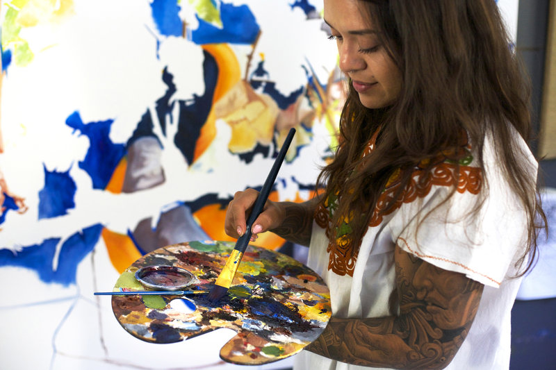 Arleene Correa Valencia works on a painting in her latest series: In Times of Crisis, En Tiempo de Crisis. CREDIT: RACHAEL BONGIORNO/NPR